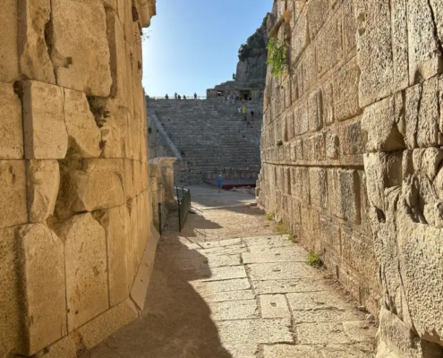 Stone passage leading towards the ancient Myra Theater, giving a glimpse into the pathways of the past