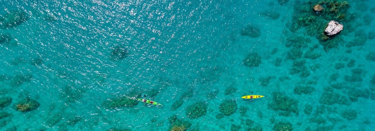 kekova-sea-kayaking-adventure-drone-shot Aerial view of Kekova sea kayaking over crystal-clear waters and submerged ruins