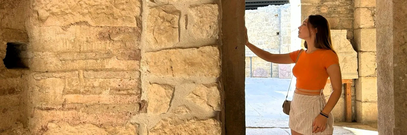 Inside view of St. Nicholas Church in Demre, with a visitor admiring the ancient stone architecture
