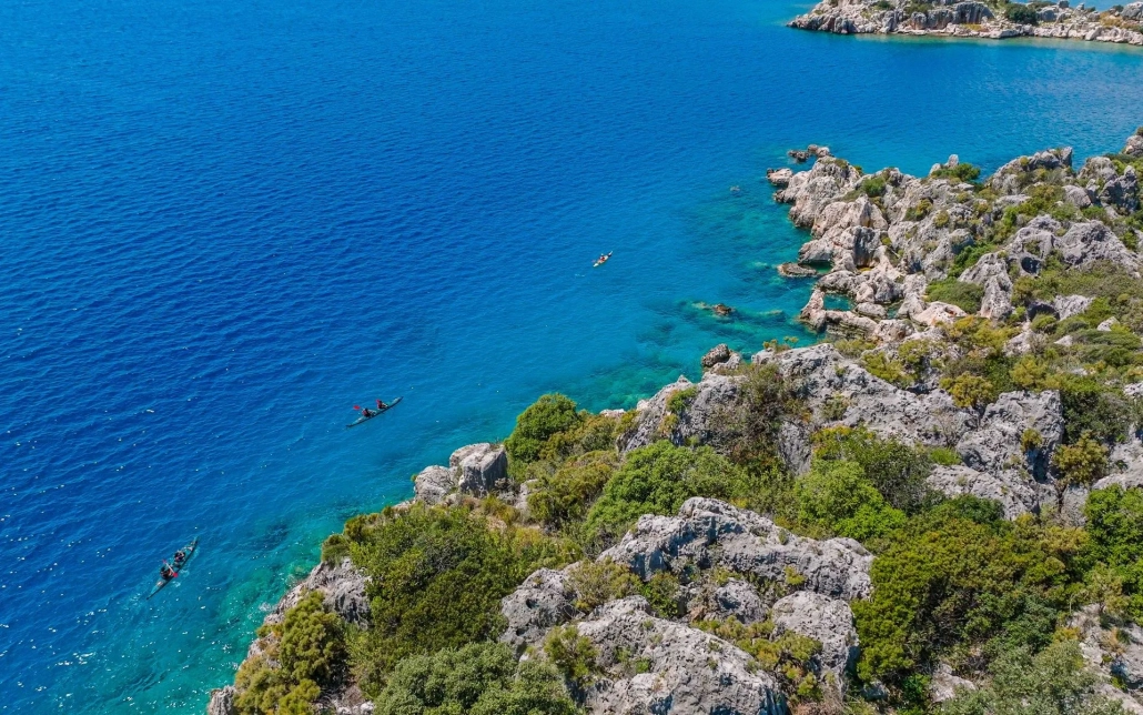 Aerial shot of kayaks passing over ancient sunken ruins in Kekova, Turkey