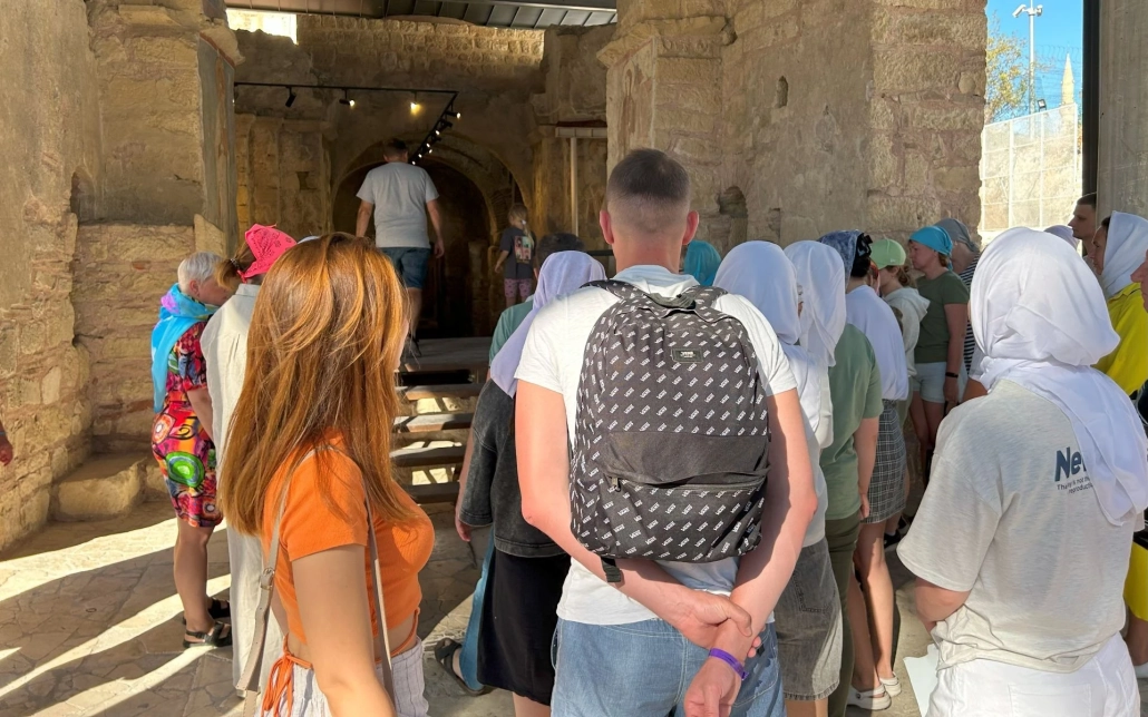 Tourists entering the historic interior of St. Nicholas Church in Demre during a guided tour.